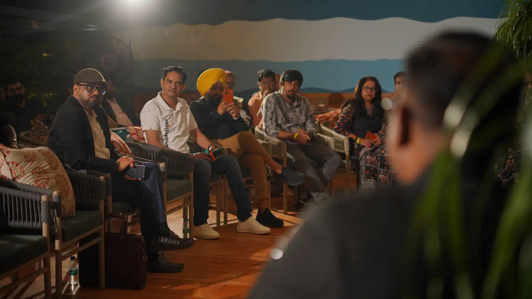 Guests seated in a semicircle listening to the panel