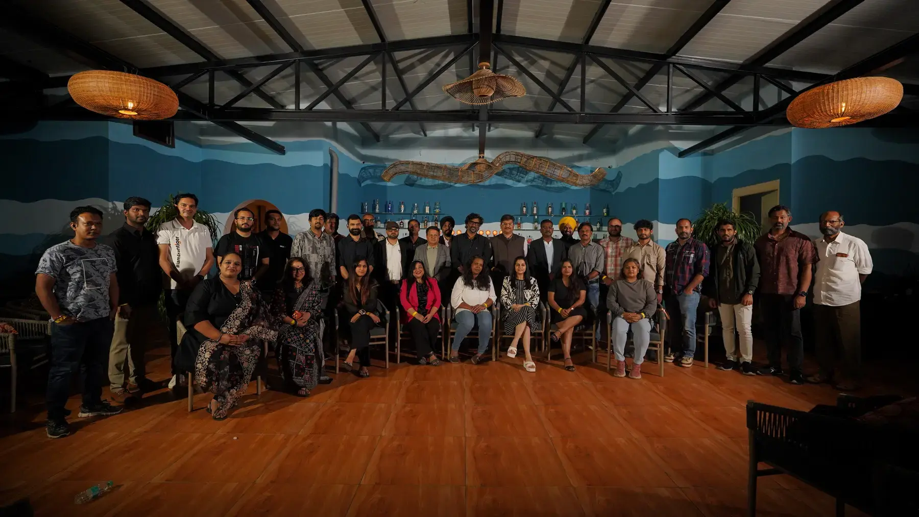 The full room at Table 125, gathered for a group photograph at Kay Koy
